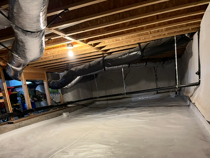 Crawl space radon mitigation with vapor barrier installation
